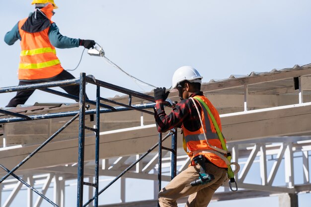 Workers installing commercial safety nets at a construction site, ensuring workplace safety.